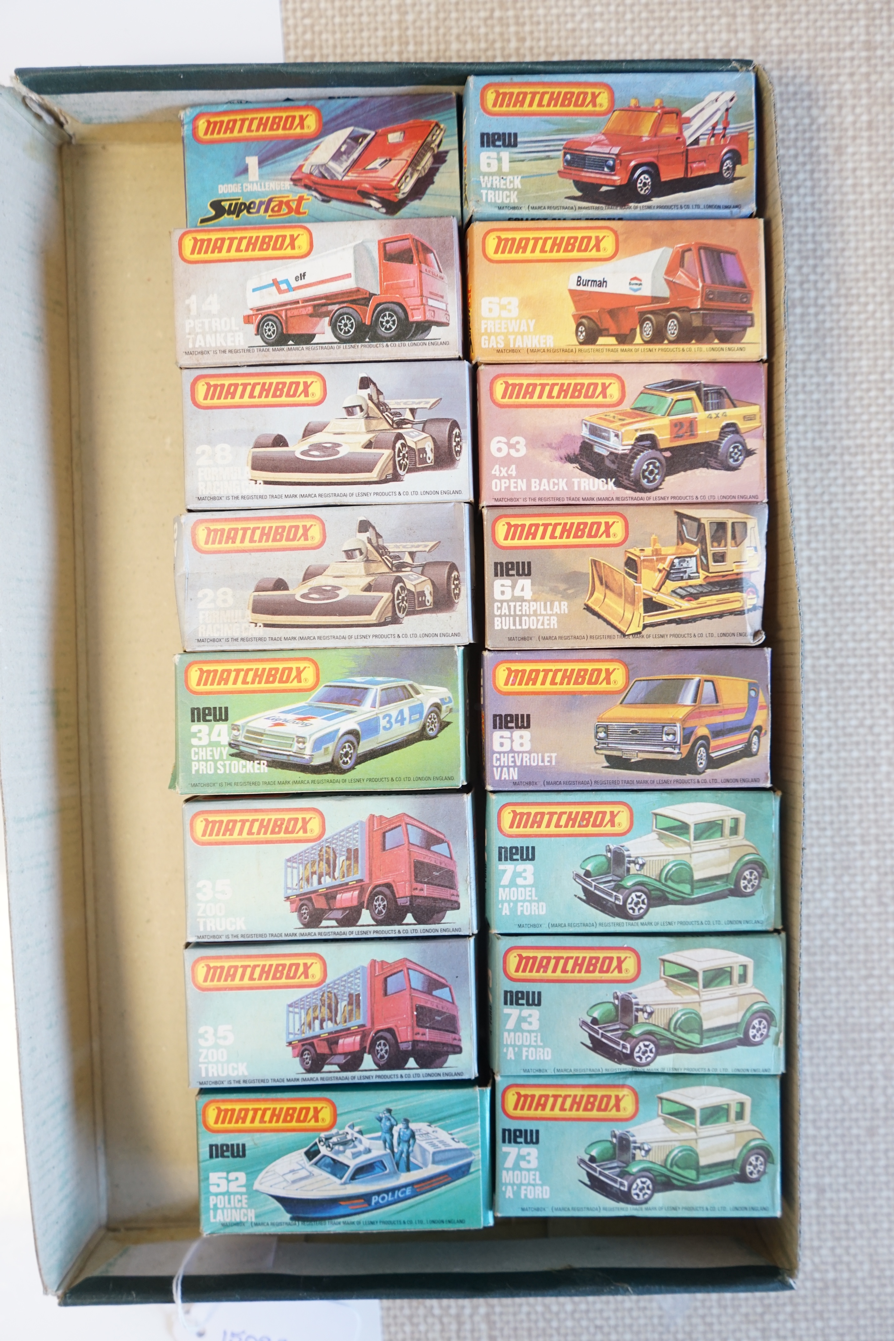 Sixteen boxed Matchbox Series 1-75 diecast vehicles including; 1; Dodge Challenger, 14; Petrol Tanker, 28; Formula Racing Car and another, 34; Chevy Pro Stocker, 35; Zoo Truck and another, 52; Police Launch, 61; Wreck Tr